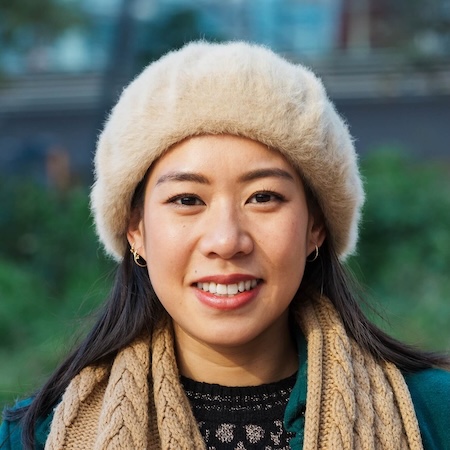 IMG-YP9Z4YQ.jpg Smiling Asian woman in a beige hat and scarf outdoors
